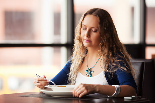 Beautiful Woman Eating A Soup At Restaurant