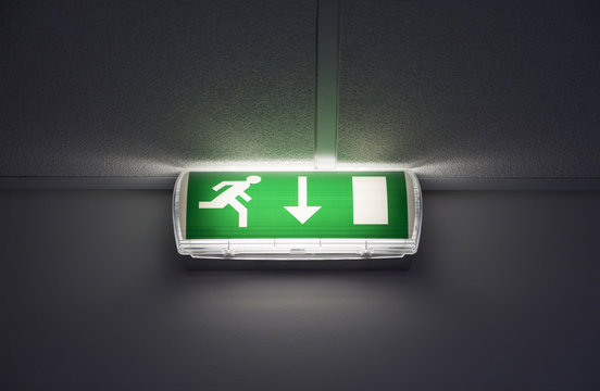 Green exit sign with running man on the wall