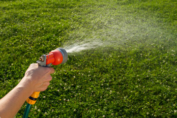 Watering the lawn with spray gun 