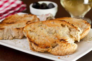 italian bruschetta on the plate with wine and olives