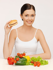 woman with hamburger and vegetables