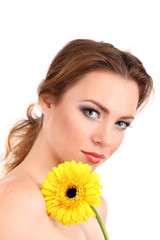 Beautiful young woman with bright make-up, holding flower,