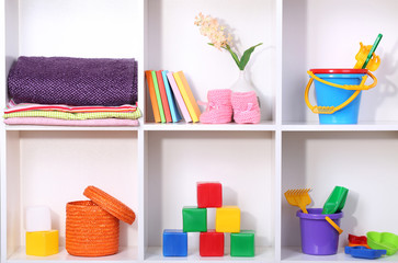 Beautiful white shelves with different baby related objects