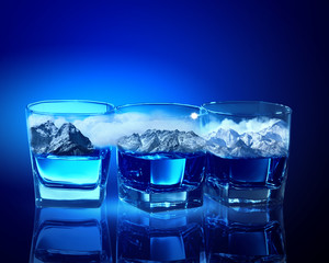 Three glasses of blue liquid