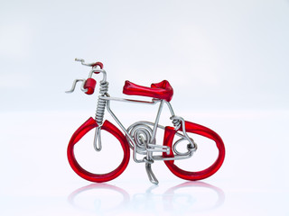 Fototapeta premium A miniature red bicycle isolated on white background in top view