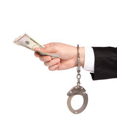 isolated hand of a businessman in a handcuffs takes bribes money