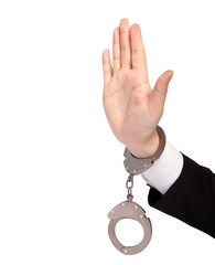 isolated hand of a businessman in a handcuffs shows a stop