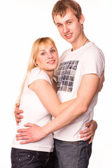 Fototapeta premium Happy smiling young couple standing together hugging