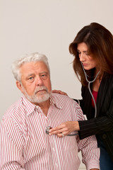 FeFemale doctor give senior male physical exam