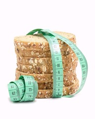 Fresh multigrain bread tied by green measuring tape.