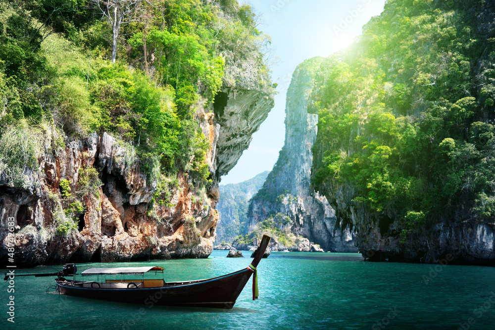 Wall mural long boat and rocks on railay beach in krabi, thailand
