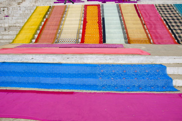 saris after washing on stair in Varanasi
