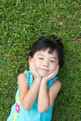 Child lying on grass