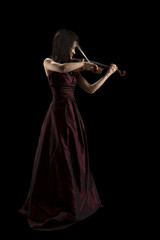young asian woman playing the violin on black