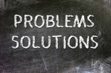 Fototapeta premium Problems Solutions handwritten with white chalk on a blackboard.