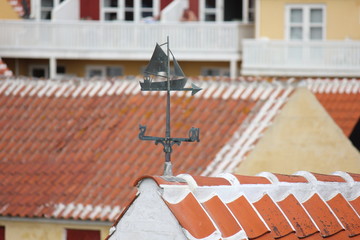 Weathervane and traditional, red-tiled roofs in Skagen, Denmark