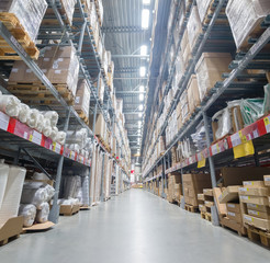 Modern warehouse with cardboard boxes and rows of shelves
