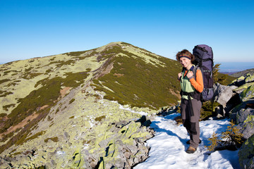 Hiker walking in autumn mountains