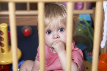 Toddler Looking Sad And Neglected In Playpen