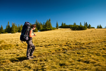 Hiker walking in autumn mountains