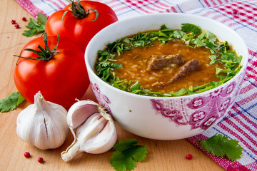 Spicy tomato soup with meat, rice and cilantro