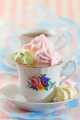 Meringue cookies in elegant tea cup