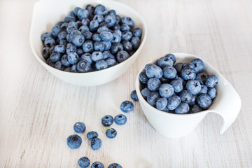 White bowl cup with fresh ripe blueberries