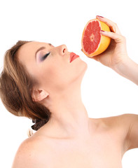 Beautiful young woman with bright make-up, holding grapefruit,