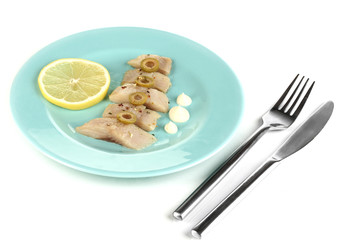 Dish of herring and lemon on plate isolated on white