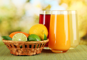 Glasses of juise with leafs and fruits