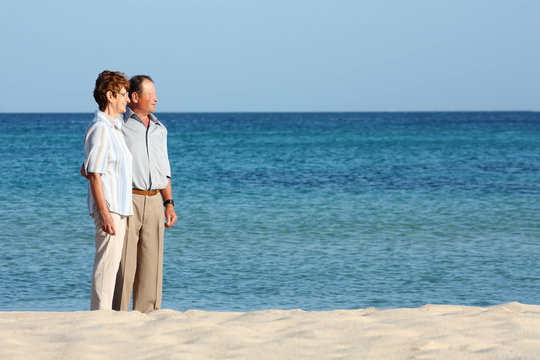 Smiling senior couple with blue background