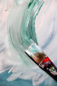 Mixing painting on the canvas and paintbrush