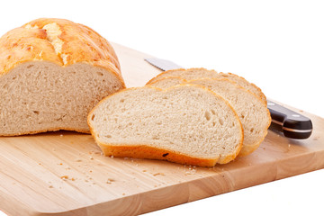 Bread on chopping board isolated on white