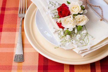 Festive table setting with flowers and vintage crockery