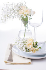 table setting with roses in bright colors and vintage crockery