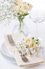 table setting with roses in bright colors and vintage crockery
