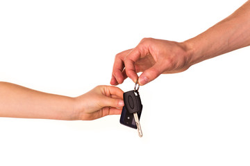 Male hand holding a car key and handing it over isolated