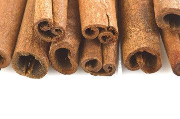 cinnamon sticks stacked on the white background