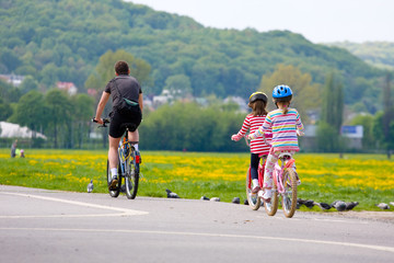 Family on bicycle ride at sunset