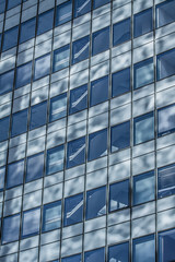 Fototapeta na wymiar Blue sky reflected in the glass building.