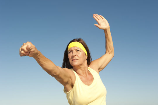 Middle aged woman exercising outdoor isolated