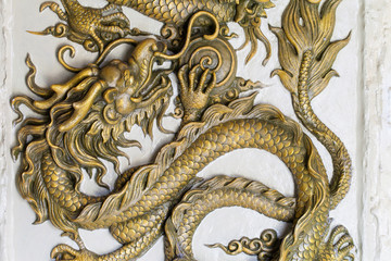 Fototapeta premium Dragon Sculpture on a wall