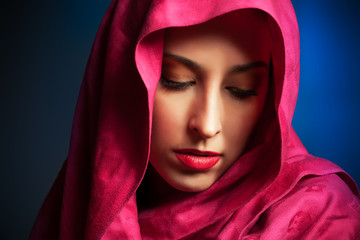 beautiful young woman with red veil around her face
