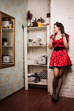 Pin-up girl in the interior of the boudoir