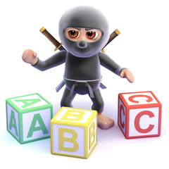 Ninja learns his alphabet with wooden blocks © Steve Young