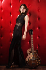 Fototapeta na wymiar Elegant woman in black with guitar