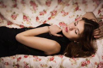 Obraz na płótnie Canvas Sensual brunette lying on the sofa