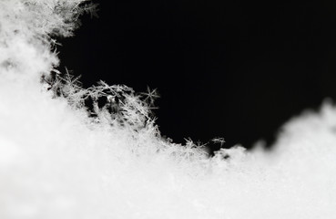 Snowflake in white snow