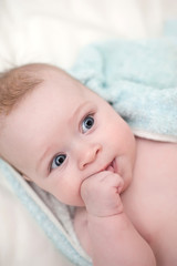 Little beautiful baby lying on a sofa.