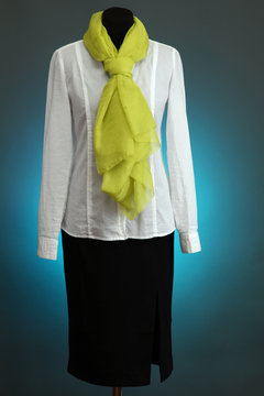White blouse, black skirt and green scarf